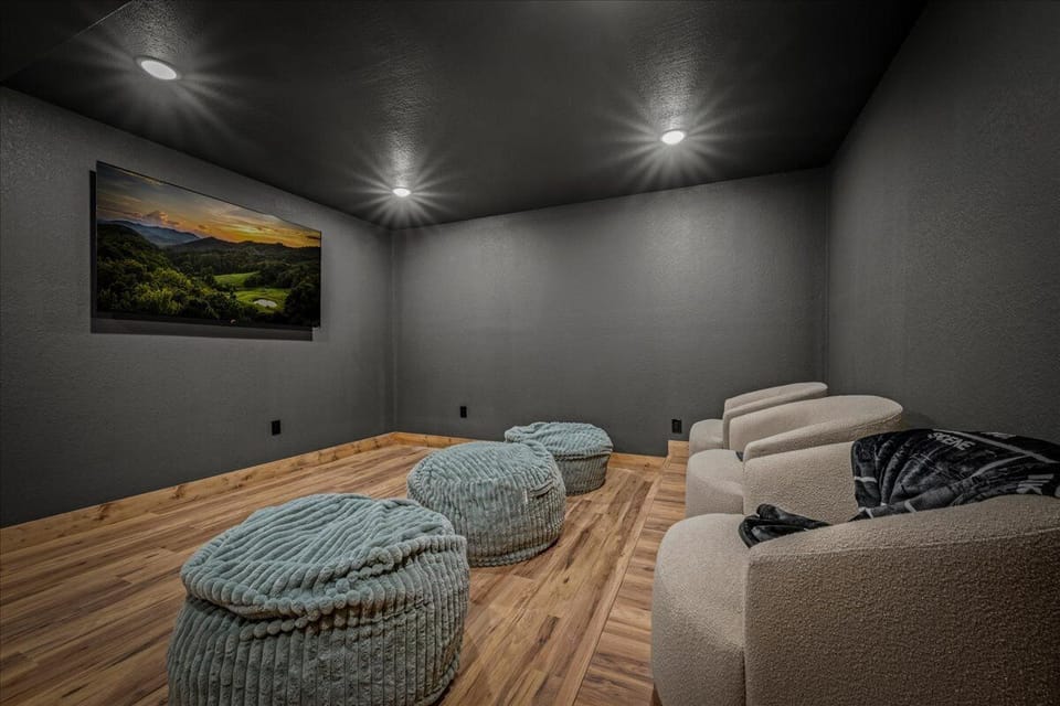 Unwind in your private theater with plush seating and cozy bean bags for the ultimate movie night experience.