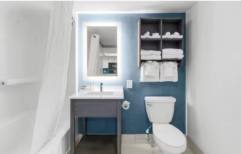 Refresh effortlessly with bright vanity lighting and plush towels.
