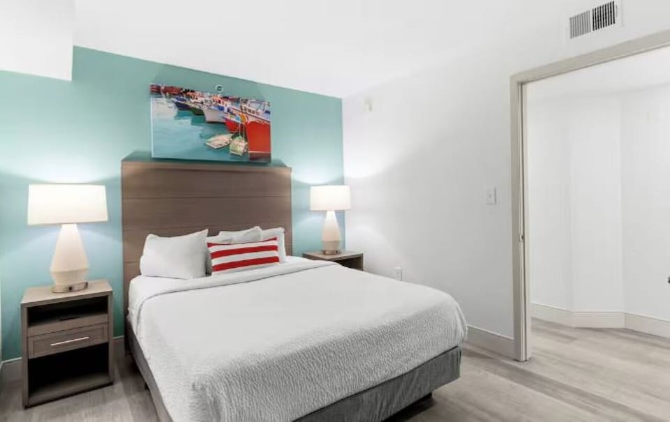 Unwind in crisp linens under soft, warm bedside lighting.