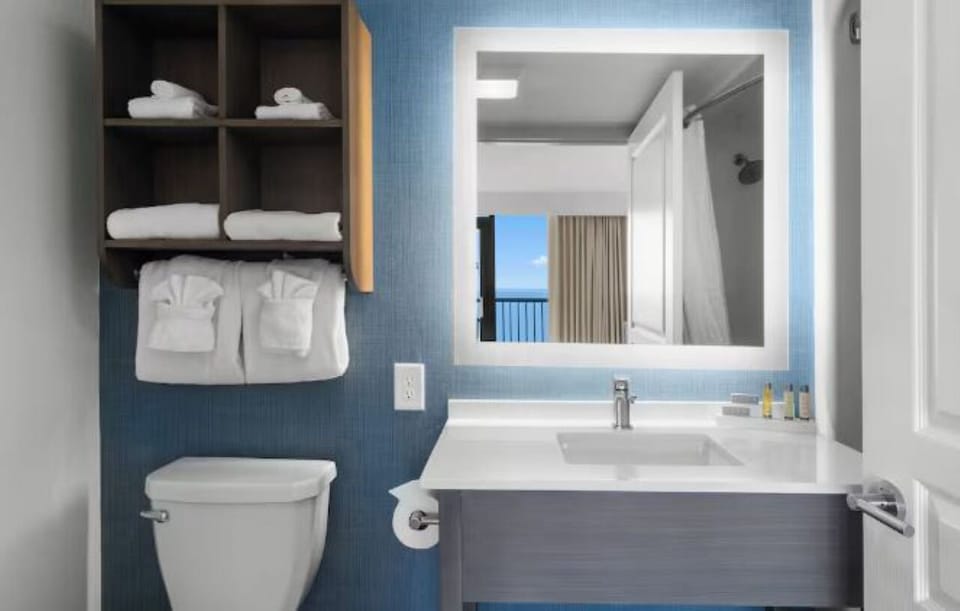 Refresh effortlessly with bright vanity lighting and plush towels.