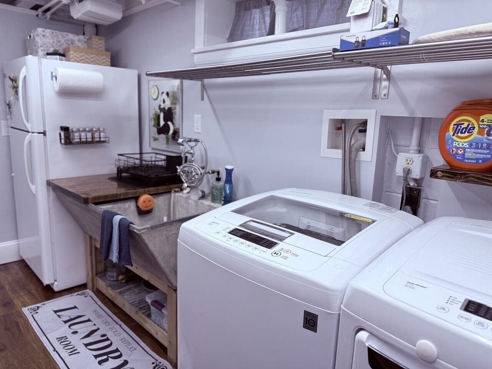 Full size washer and dryer, tub sink, and refrigerator.