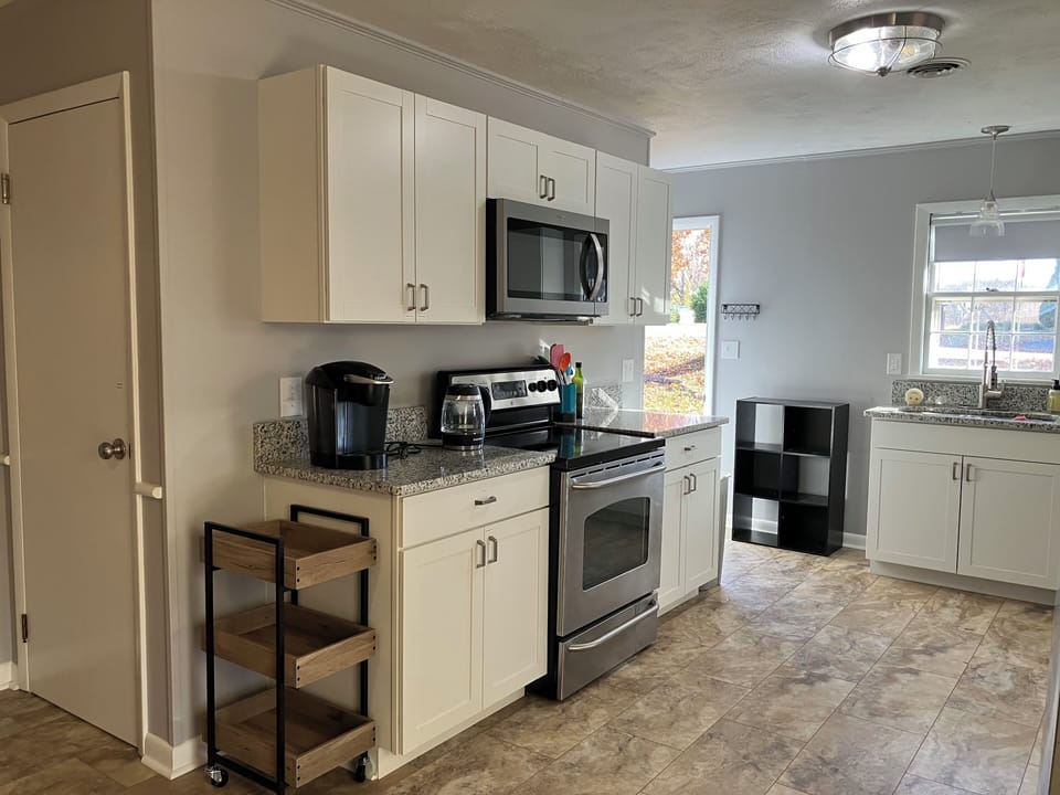 Full Kitchen with dishes and appliances to  prep any meal. Door to basement.