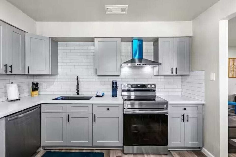 Fully equipped kitchen with stainless steel appliances, sleek quartz counters, and everything you need to cook and dine in comfort.