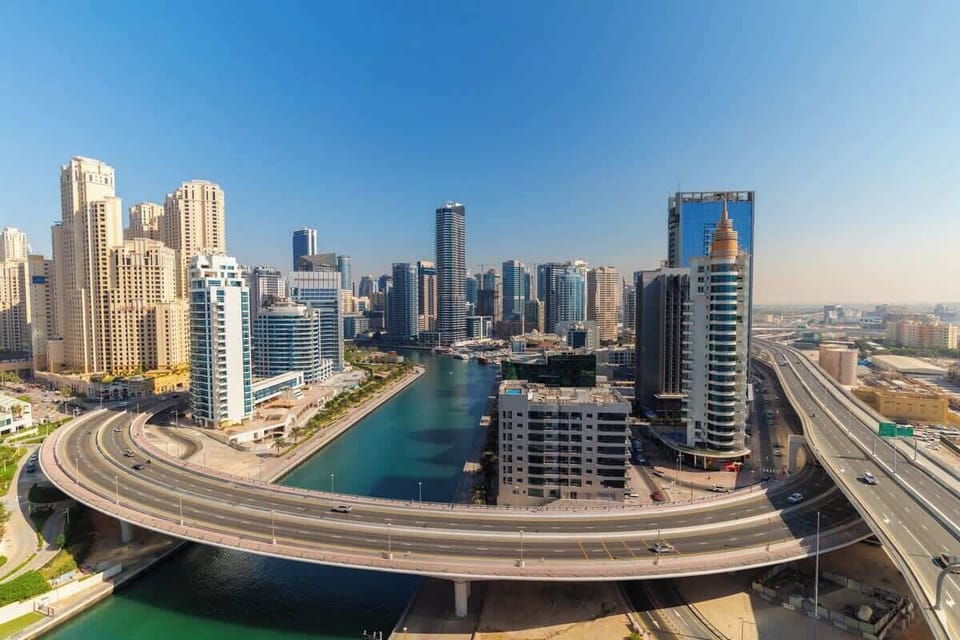 A panoramic view showcasing the winding marina and impressive city skyline, blending tranquility and energy.