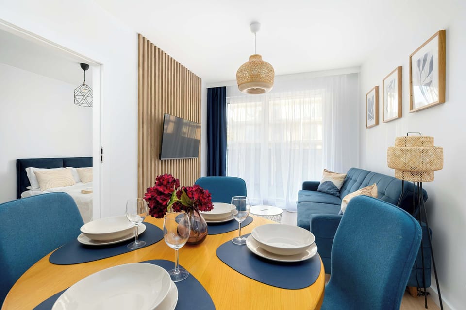 Elegant dining space with round table, upholstered chairs, and warm lighting.