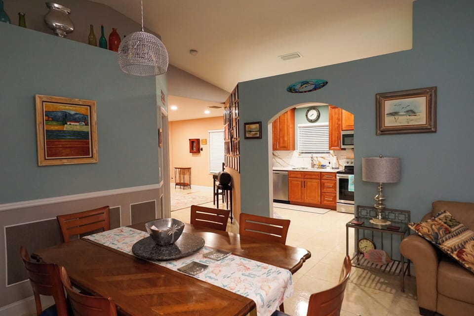 Dining area in open floor plan with high ceilings.