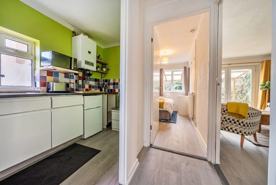 A handy overview of the layout showing the kitchen, hallway, bedroom, and living space beyond.