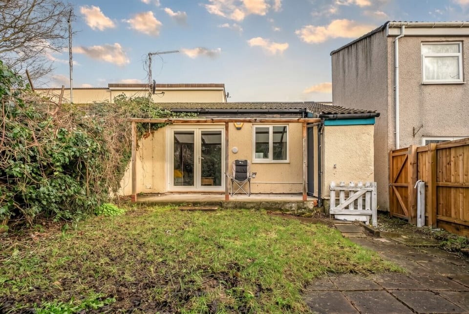 Private rear garden with a covered patio and French doors leading straight into the living room.