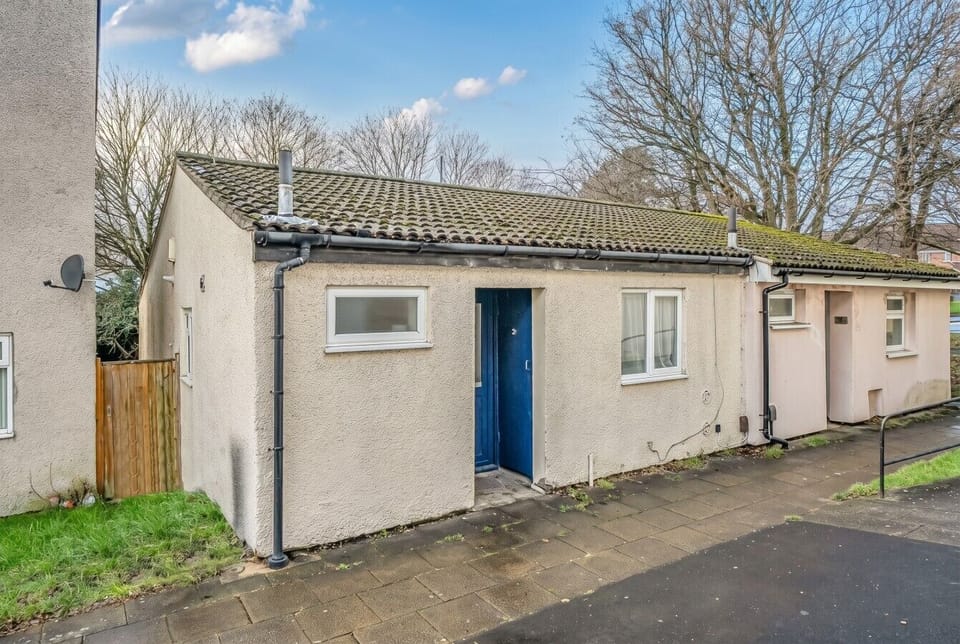 The distinctive blue front door marks the entrance to your self-contained bungalow.
