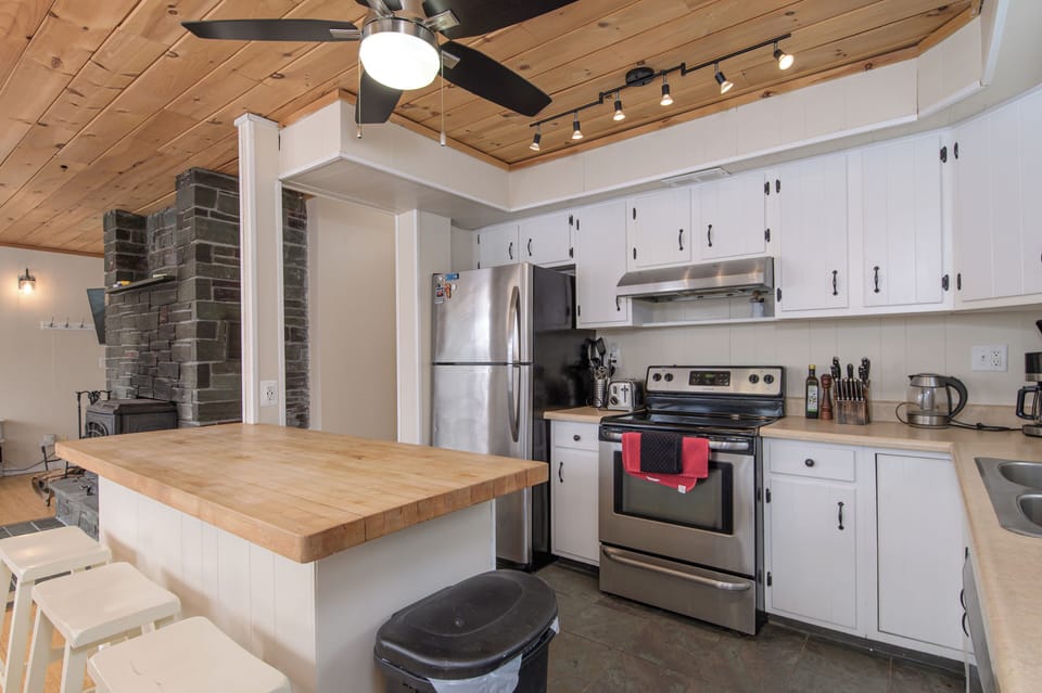 Whip up your favorite dishes in the fully equipped kitchen with a butcher-block island, perfect for gathering over meals.