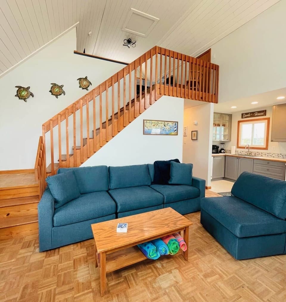 Open living room with comfy seating and a 65" TV