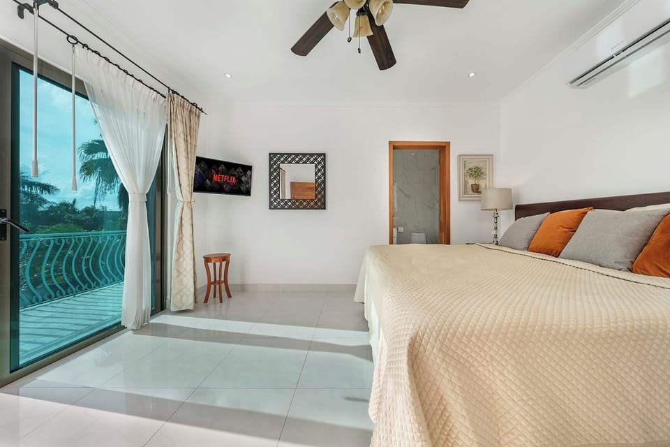 Master bedroom. King bed, private balcony, walk-in closet, and private bath
