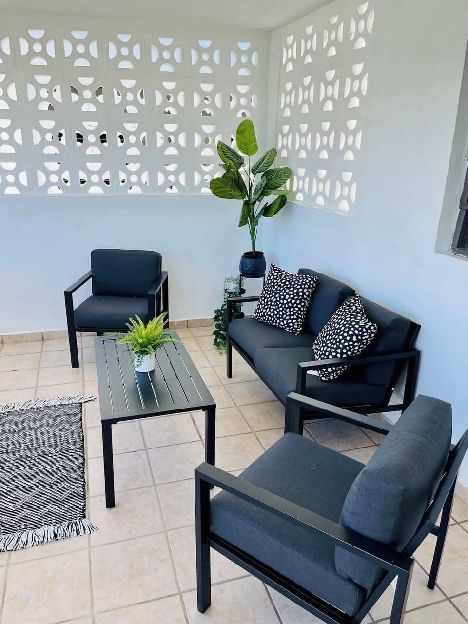 Charming front patio with comfy seating to relax and enjoy.