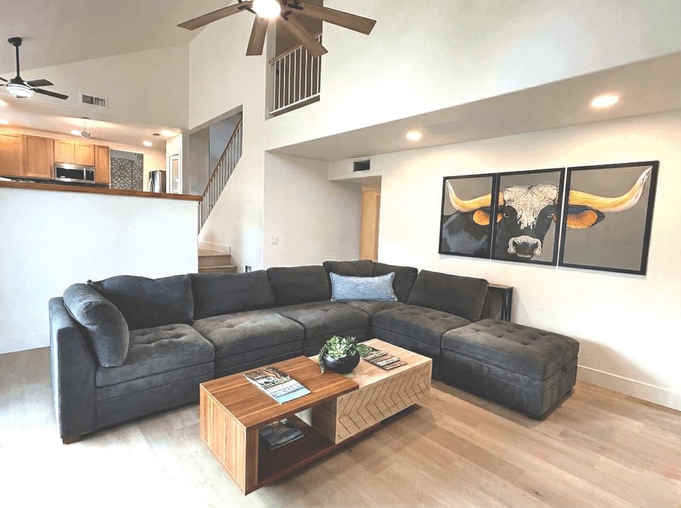 Large living room has an extra large sectional, individual chairs, big screen smart TV, board games, two different areas to charge your devices.
