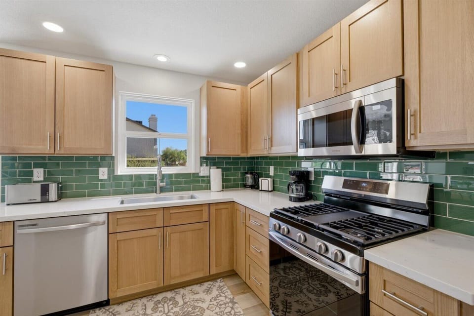 Just-remodeled, well-stocked kitchen. Ground coffee is provided for drip coffee maker. There is also an electric kettle, blender, waffle maker, and lots of pots, baking pans, etc