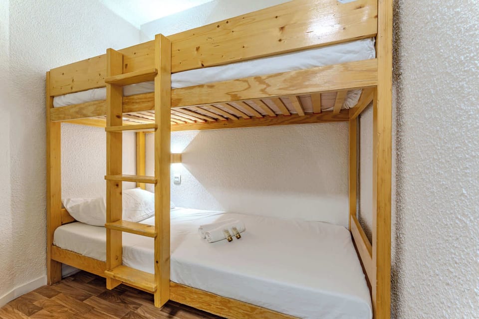 Cozy alpine bedroom with bunk bed (double below, single above) — perfect for families or friends in the heart of Val Thorens, just steps from the slopes.