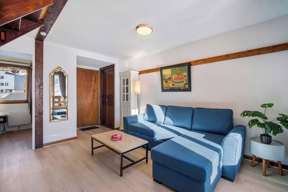 Open-plan living space connecting to kitchen and upstairs bedrooms, with authentic wood touches.