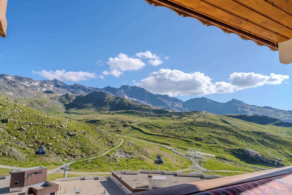 Large windows flood the apartment with natural light and open to the balcony for fresh mountain air.