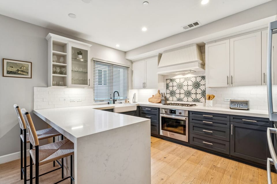 Bright kitchen w/ sleek counters, ample cabinetry & a clean, modern feel