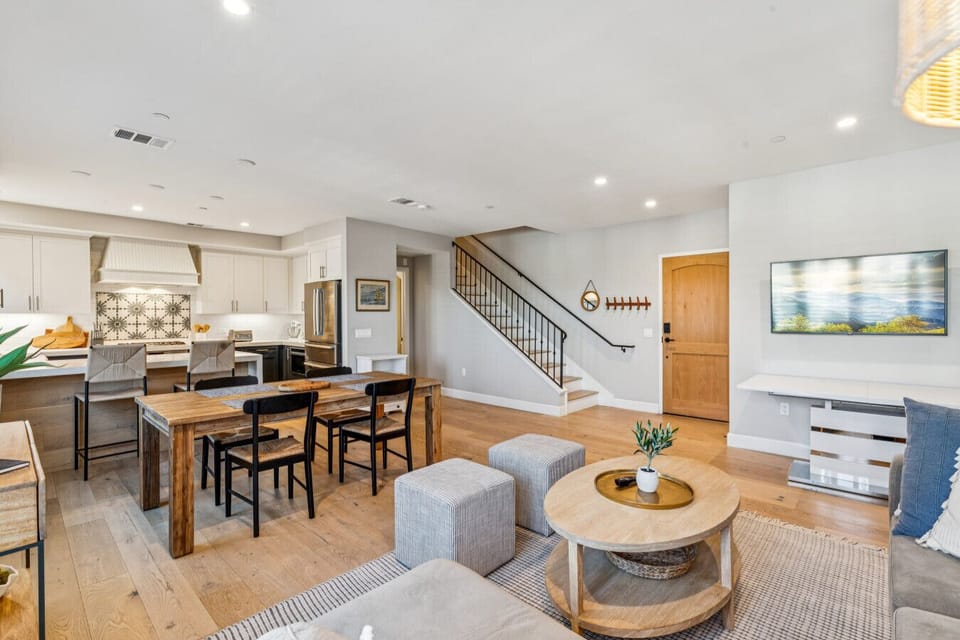 Airy open-concept space w/ dining table, lounge seating & a relaxed coastal vibe