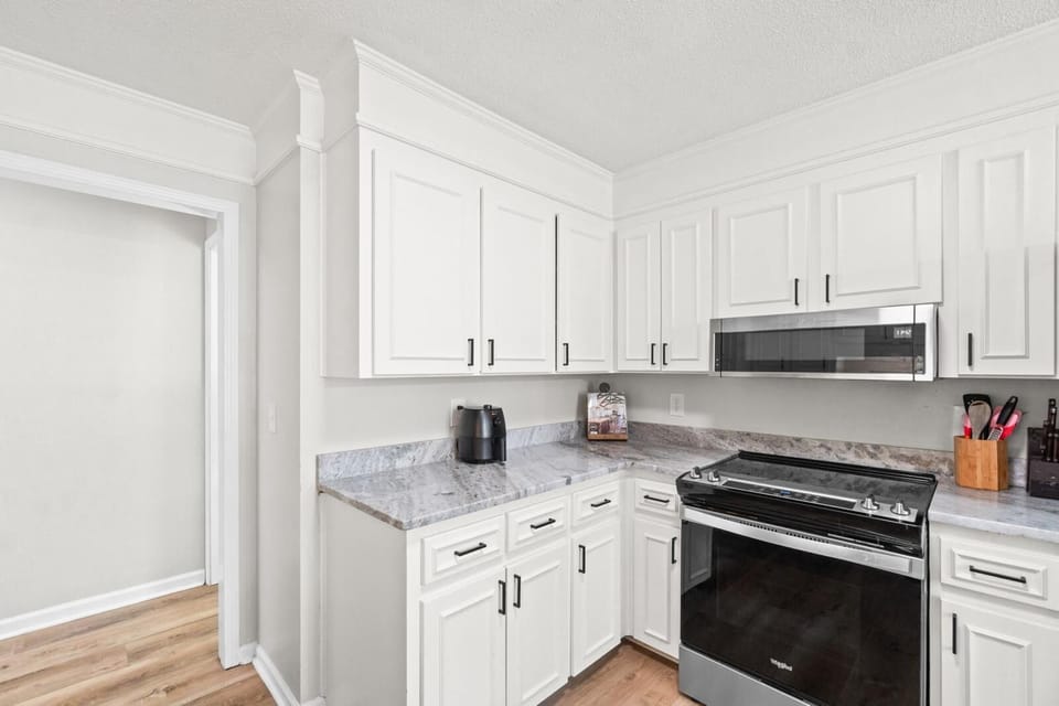 Kitchen with bar seating and all appliances