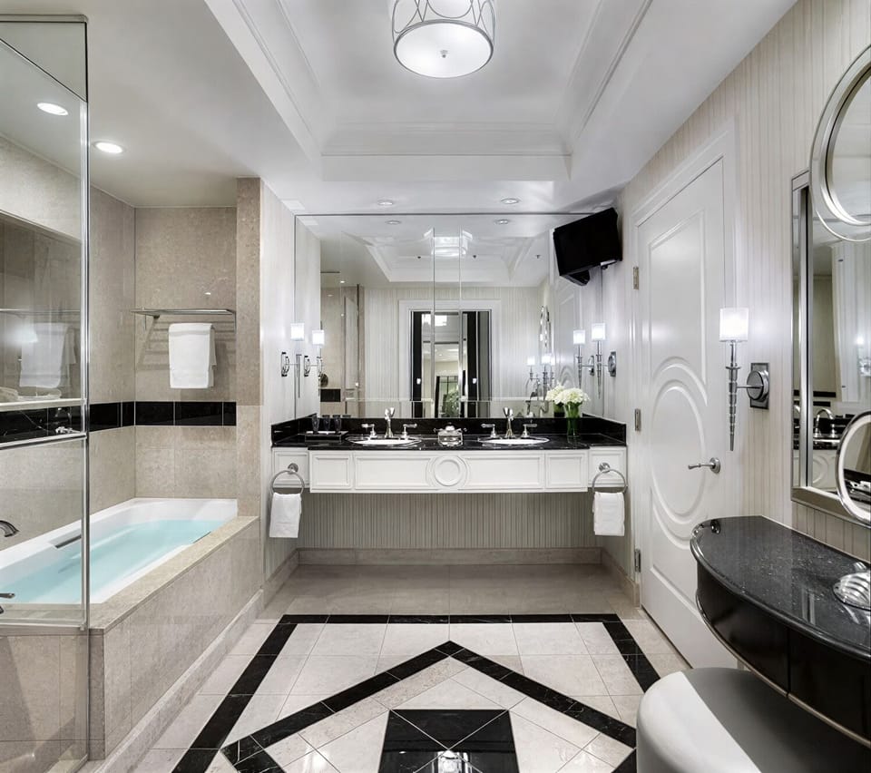 Refresh in a marble bath with deep soaking tub.