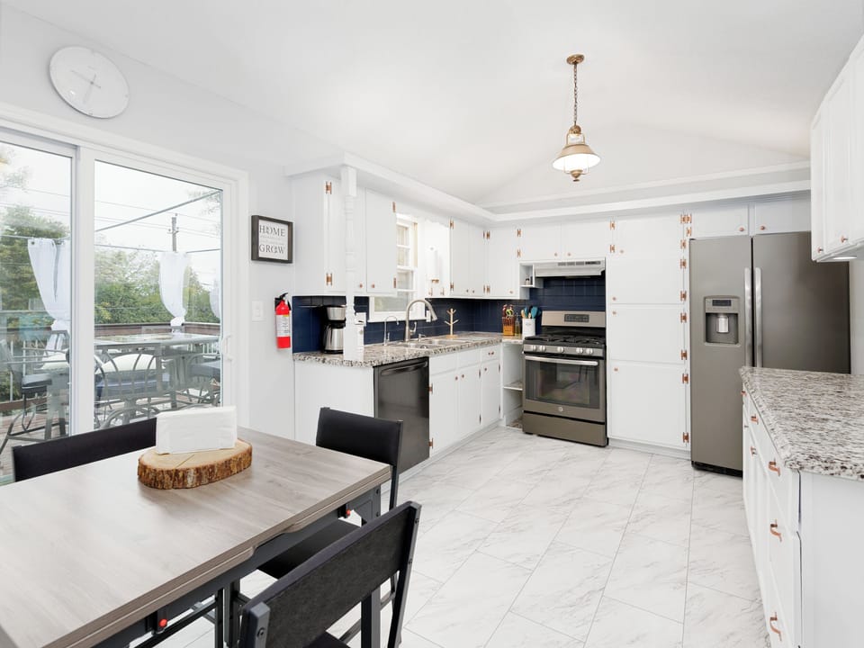 Spacious, light-filled kitchen featuring full-size appliances and generous counter space for everyday cooking.