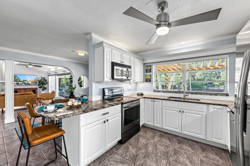 A large kitchen window looks out onto the canal, filling the space with natural light.
