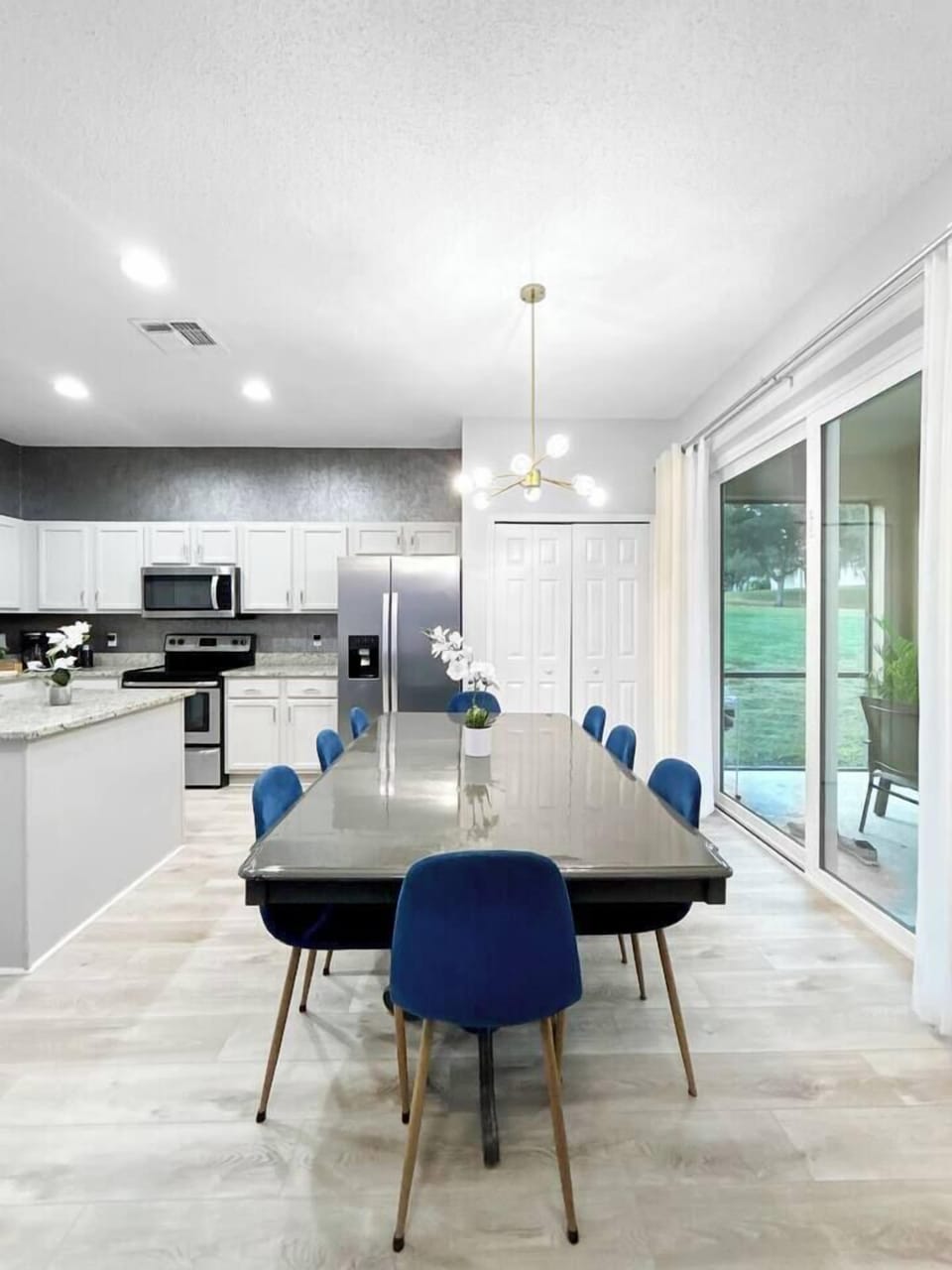 Spacious kitchen dining area with seating for 10, featuring bright natural light and easy access to the patio and pool. Perfect for family meals and gatherings, just steps from the newly equipped kitchen for smooth, convenient dining.
