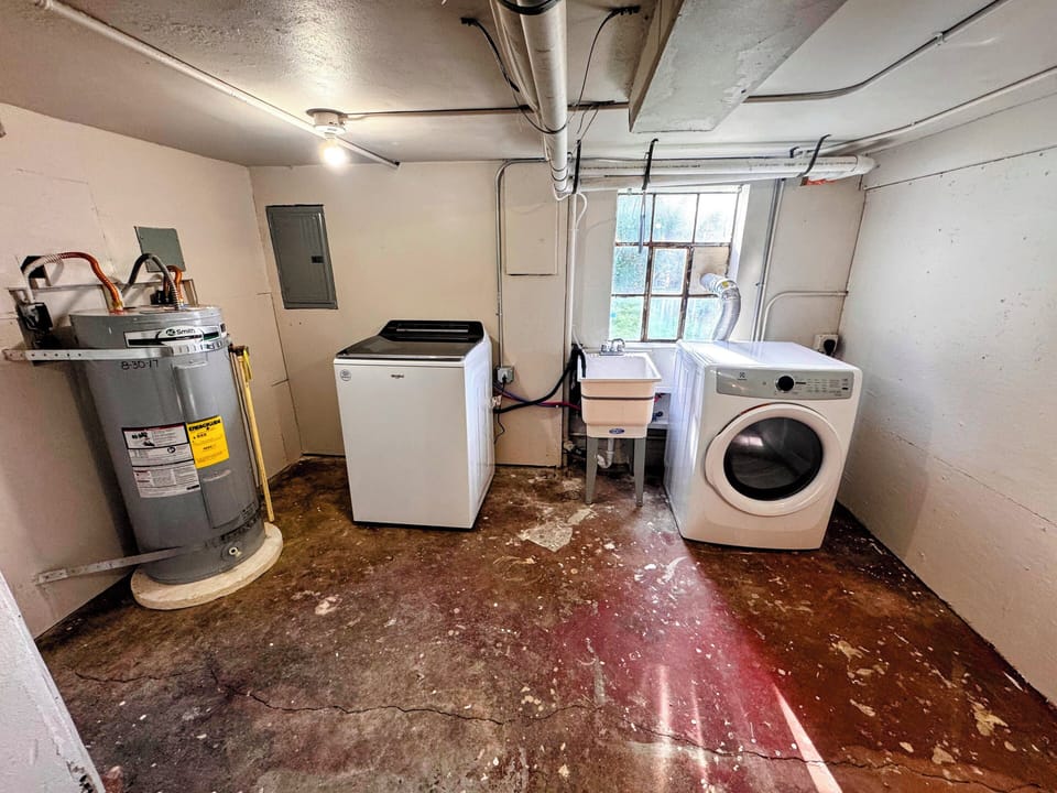 Basement access to private laundry, electric panel, water heater, and furnace