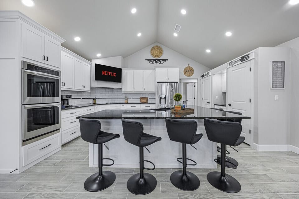 Fully stocked open concept kitchen with bar seating for 6