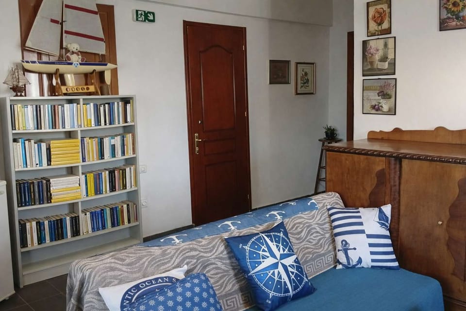Cozy living room area featuring a well-stocked bookshelf and comfortable seating, ideal for reading, relaxing, or enjoying a quiet moment indoors