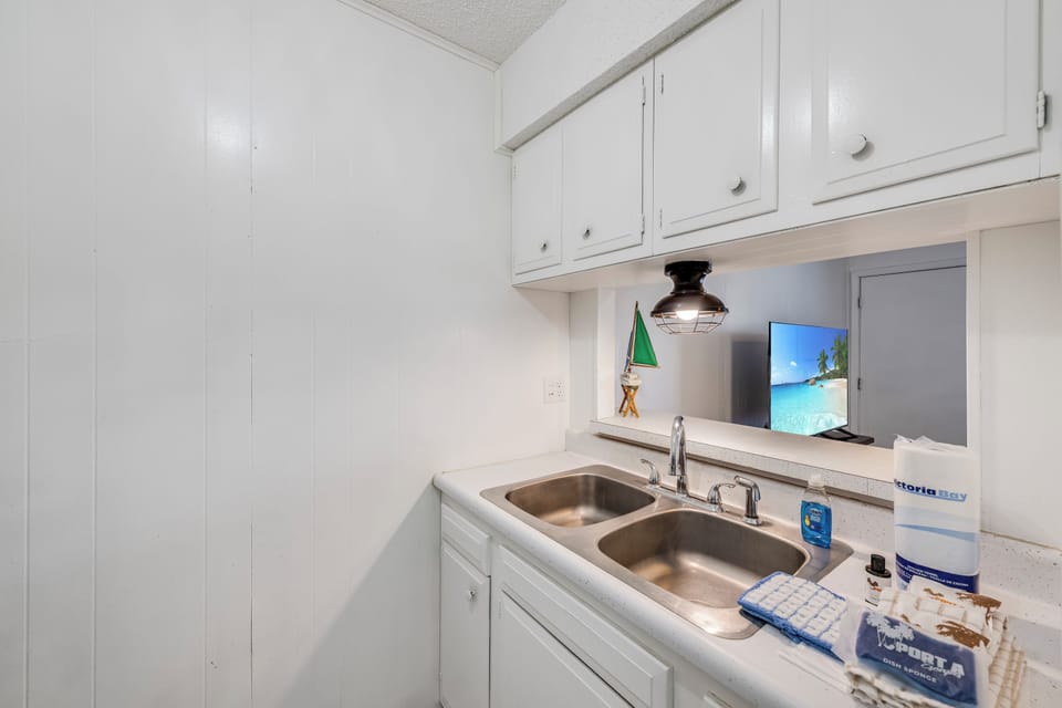 Your bright kitchenette features everything you need for easy meal prep with modern appliances and coastal charm.