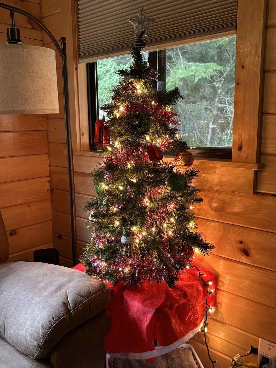 Cozy corner with festive tree and warm wood walls