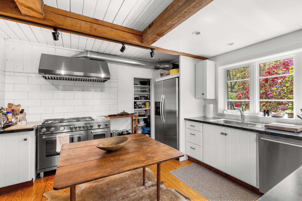 A spacious kitchen island, generous counters, and stainless appliances make beach week meals simple and social.