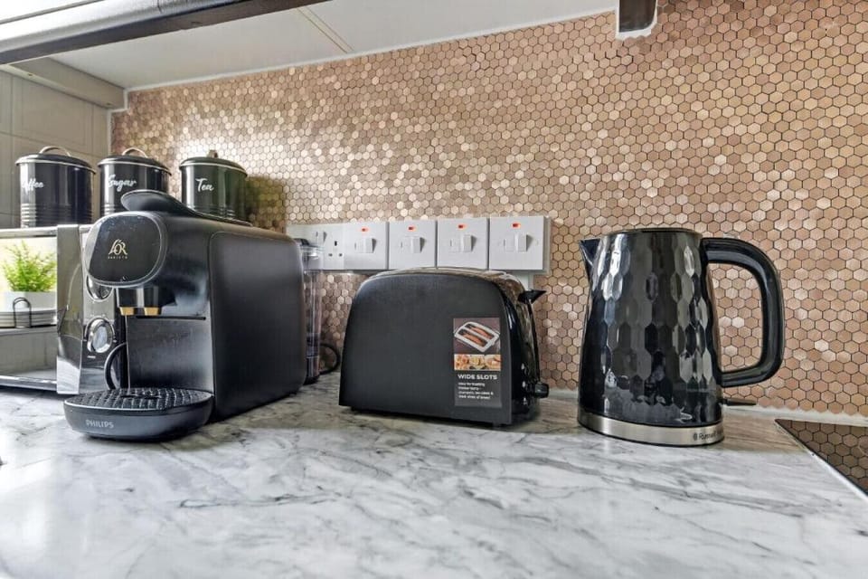 Make tea or coffee using the kettle and appliances on the kitchen worktop.