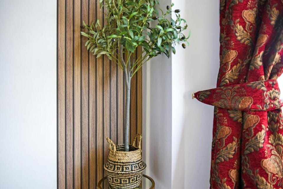 Add a finishing touch with the decorative plant and curtain detail in the living area.