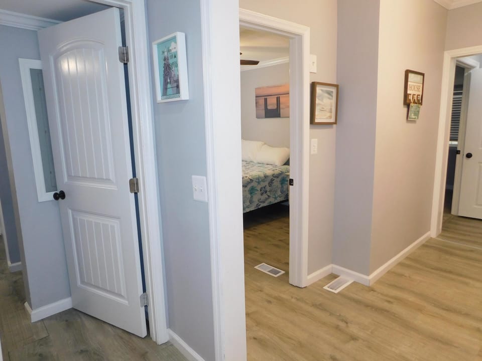 View from hall bath, bunk room to the left, queen straight ahead and the king/handicap shower at the end of hall. Laundry is in this hall.