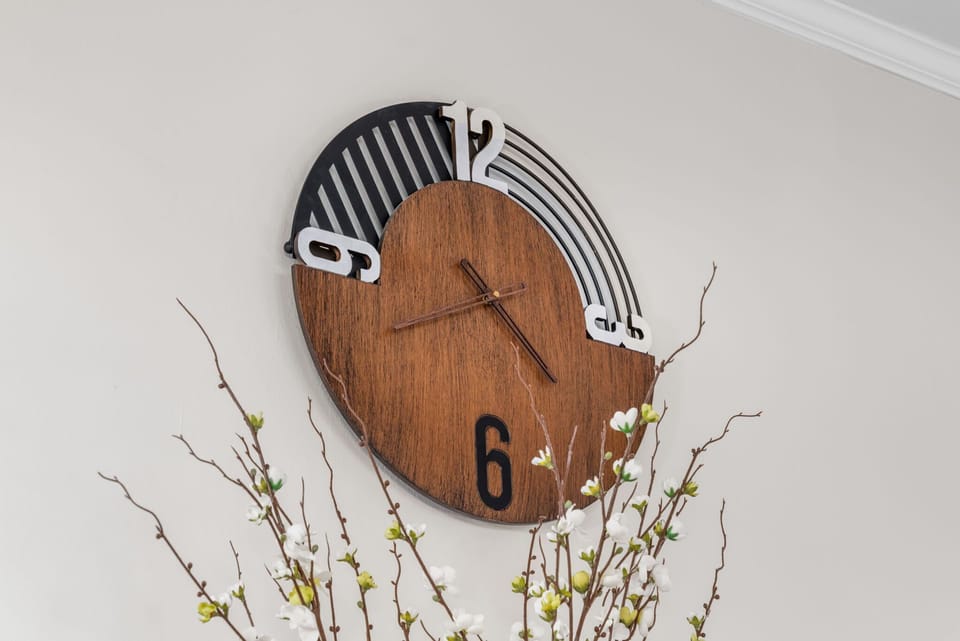 Modern wall clock with natural wood finish. Subtle design detail that complements the room’s aesthetic.