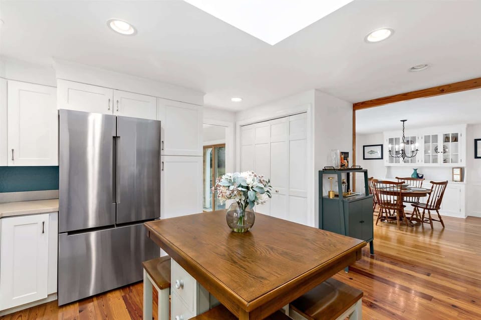 Kitchen island doubles as a gathering spot, with sight lines to the dining room and plenty of counter space for meal prep.