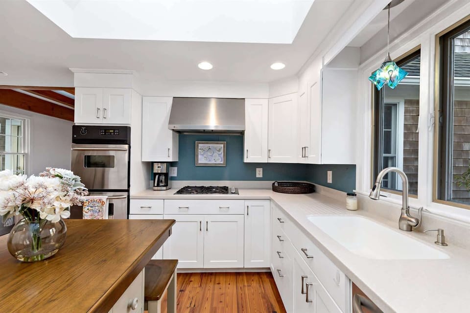 Cook with ease on the gas range and enjoy your meal on the island. A sunny window over the sink and coastal pendant lights add beauty. 