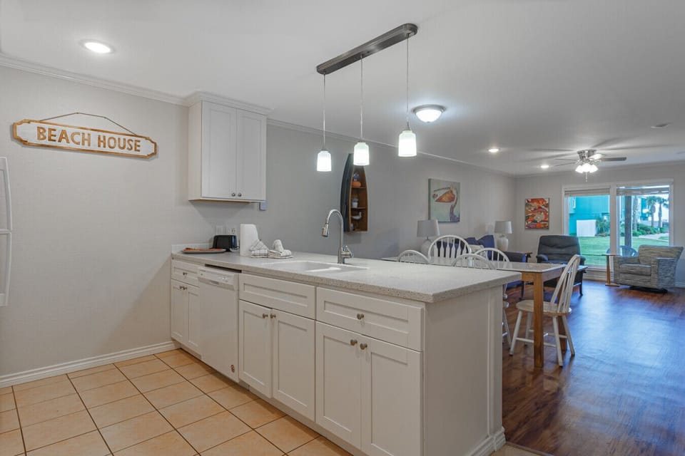 Open kitchen with island seating flowing into living area