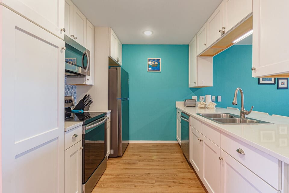 Bright galley kitchen with coastal color accents