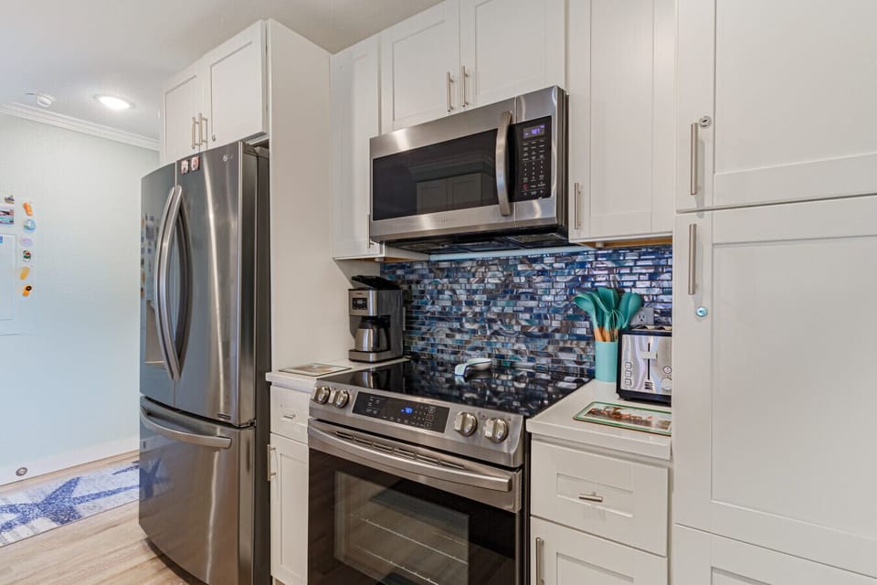 Updated kitchen with mosaic tile backsplash