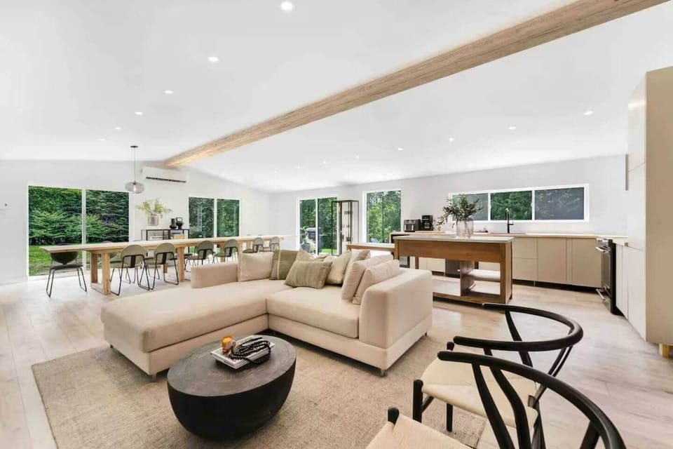Bright and spacious open-concept living area with large windows and comfortable modern seating