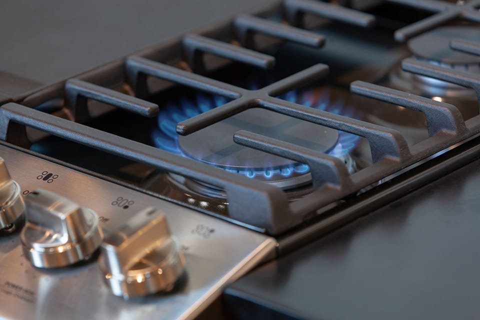 The kitchen is equipped with a gas stove and oven