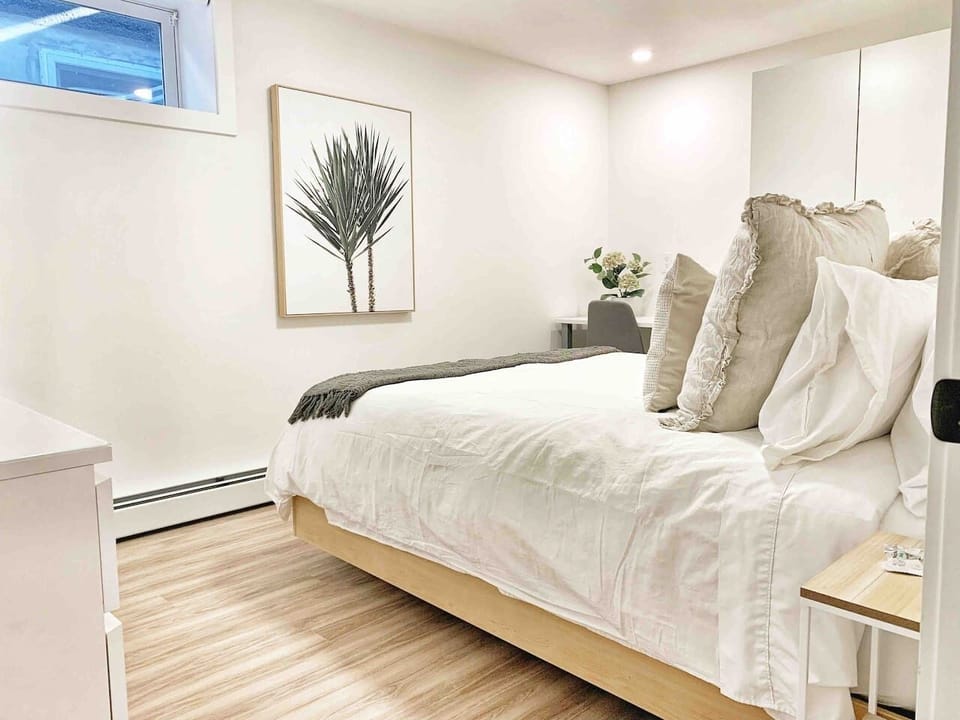 Alternate view of the primary bedroom, showing clean lines, quality linens, and an uncluttered layout designed for rest.