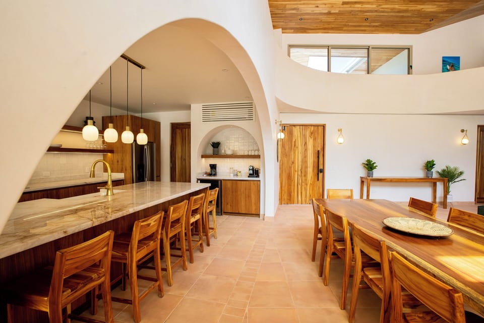 Enter into the curvy gathering space and kitchen and feel instantly at home