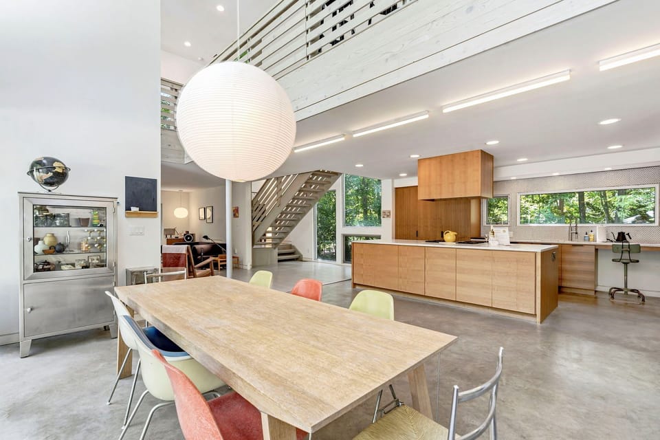 Open great room with double-height ceilings and Noguchi pendant