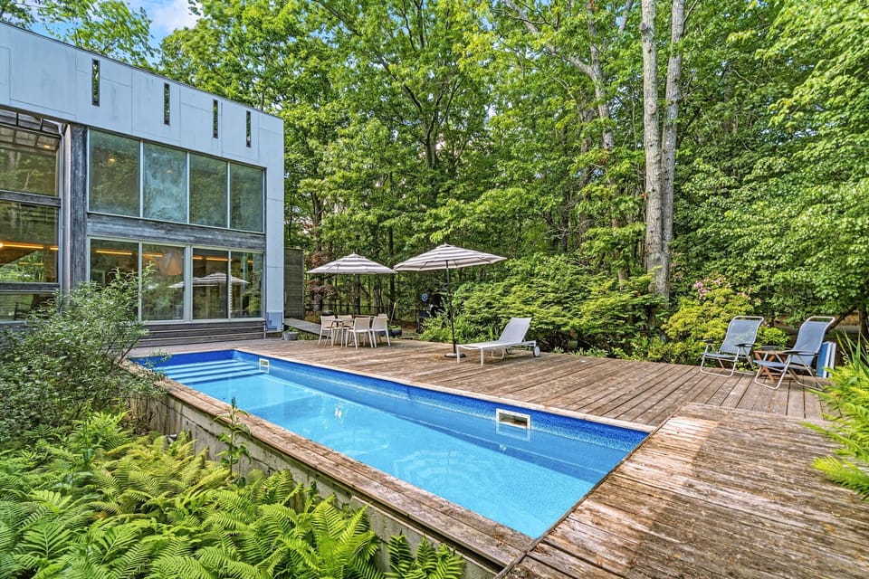 Lap pool with wood deck and wooded privacy
